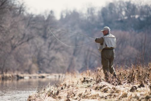 Editorial photography with the Des Moines Register shows man fly fishing.