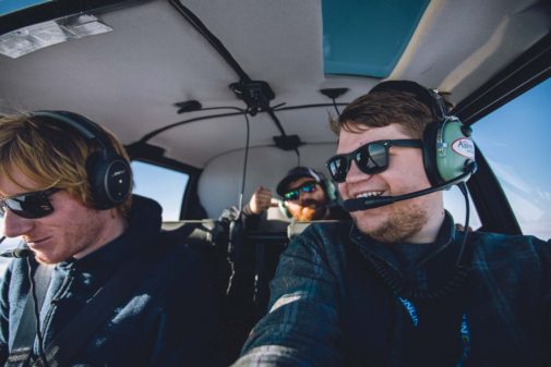 video production crew flying in helicopter across Alaska