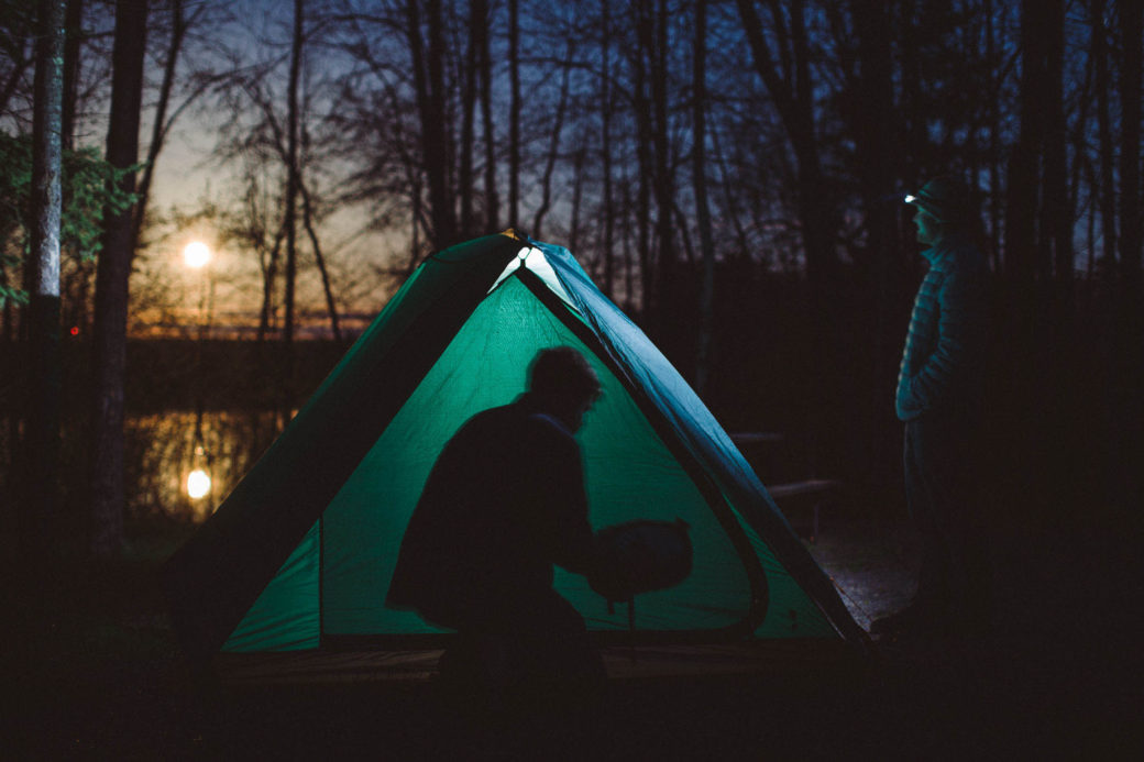 moon rises behind tent while camping