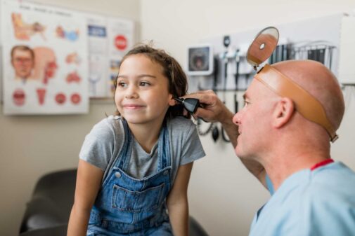 doctor inspecting child's ear