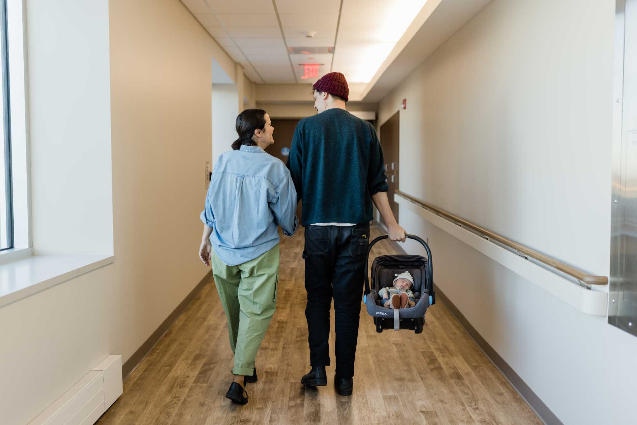 couple leaving birthing center with baby